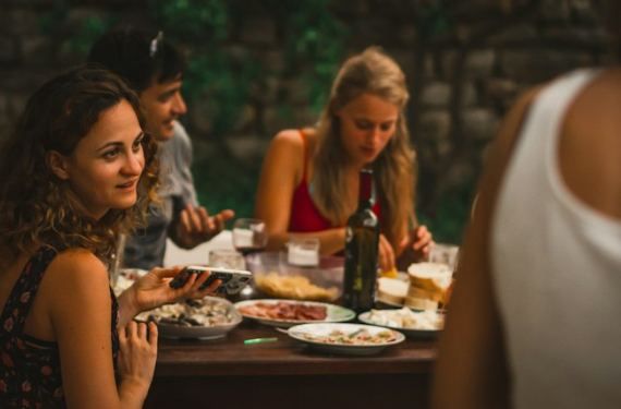 Friends sharing dinner around an outdoor table